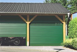Pair green Seceuroglide automatic roller garage doors with vision slats